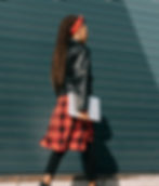 African American teen girl in red and black holding a computer