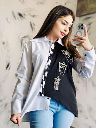 Asymmetrical black and white shirt embroidered with diamond-effect stones. Design by Samanta X