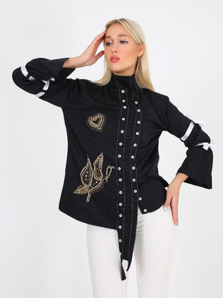 Asymmetrical women's black shirt with bows on the sleeves and embroidered with golden stones. Design by Samanta X