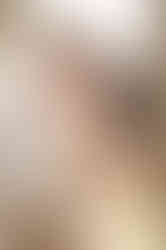 Couple intimately embrace with their foreheads touching.