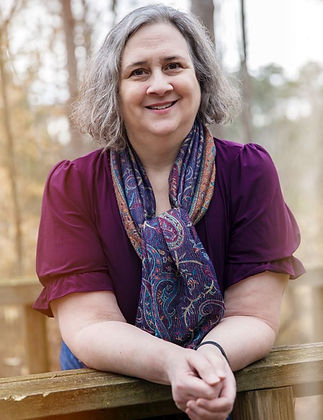 Portrait of Janet Banks, a nurse and life coach, smiling outdoors.
