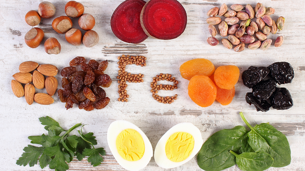 iron-rich foods laying on a surface with seeds in the shape of "Fe" in the middle of the foods