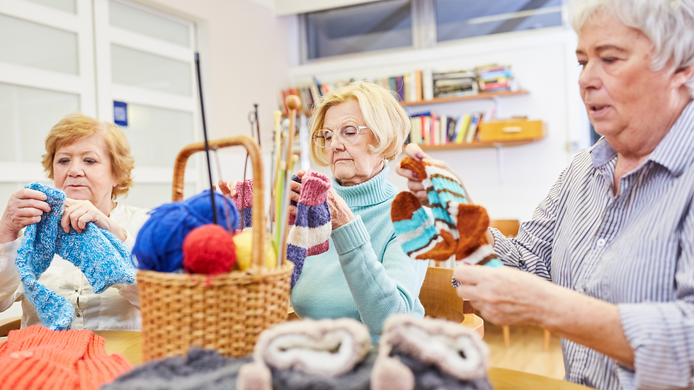 Three senior women knitting together