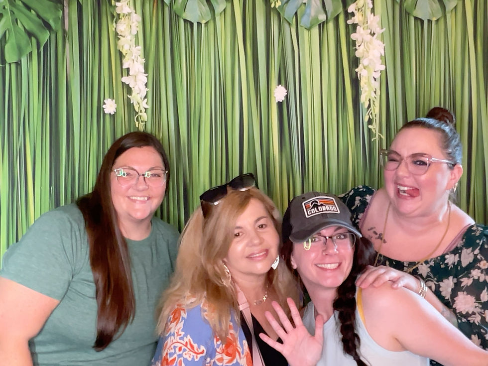 four caregivers smiling and posing in a photobooth