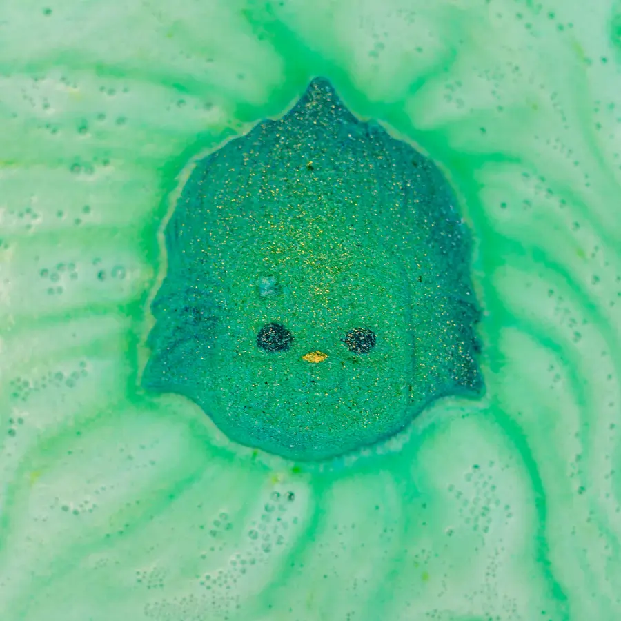 Green Baby Grinch Bath Bomb foaming in water