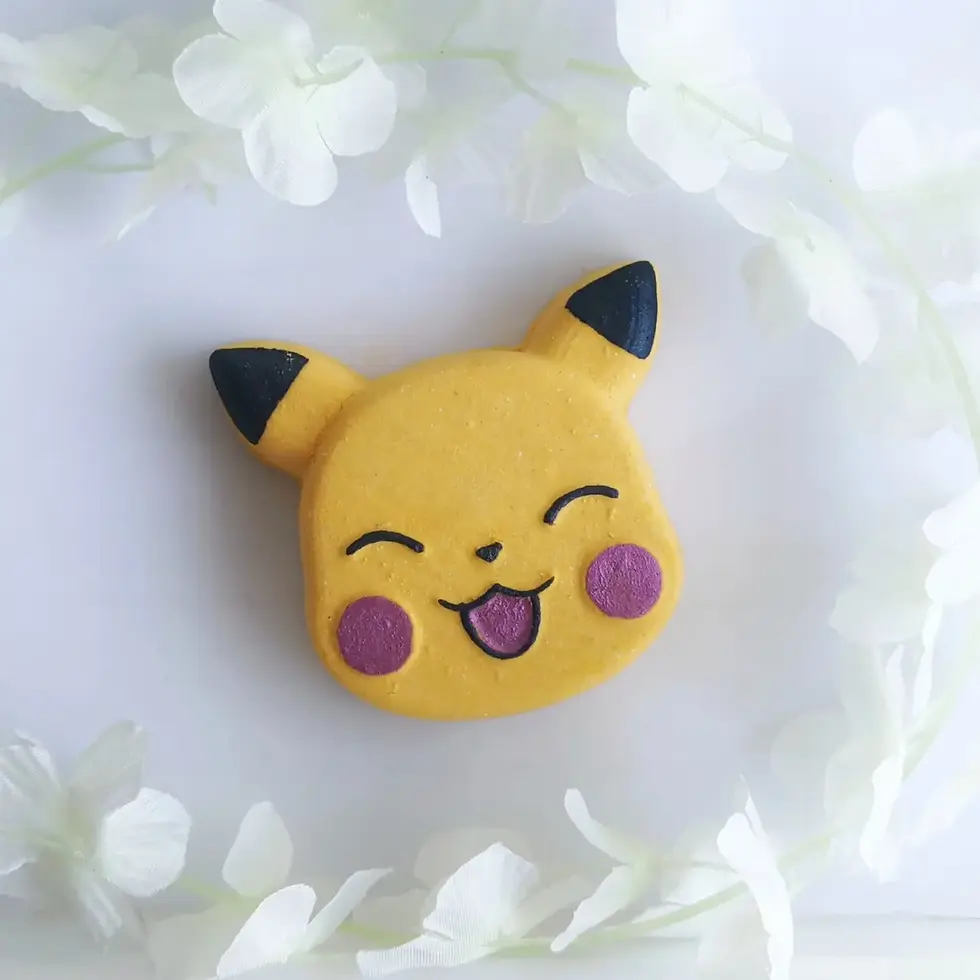 A Yellow P-Chu Poket Monster Bath Bomb surrounded by white petals on a wire