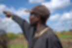 A Zambian man points at the distance
