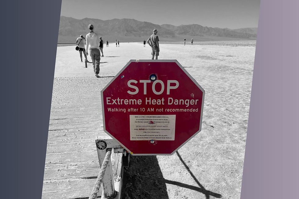 People walking past a red octagonal sign writing "STOP Extreme Heat Danger Walking after 10 AM not recommended"