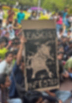 Student protesters hold a “FASCIST INFESTED” sign