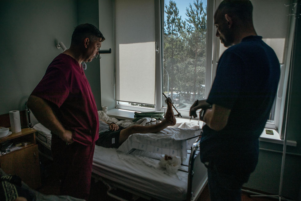 Two doctors observe a recovering patient's foot