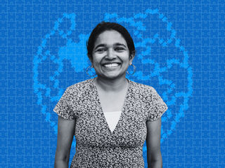 Netha Hussain, an Indian woman, in front of a stylized blue puzzle globe background