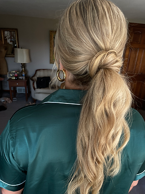 Voluminous bridal ponytail with soft waves and lived-in texture — ideal for brides seeking a fun, confident, and effortlessly chic wedding look in Colorado Springs or nearby mountain venues
