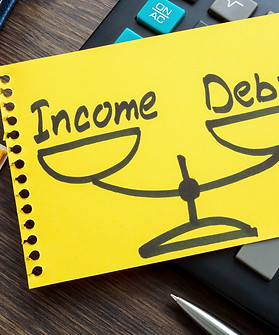 Debt to income ratio DTI concept. Page from a notebook with drawn weights lies on a calcul