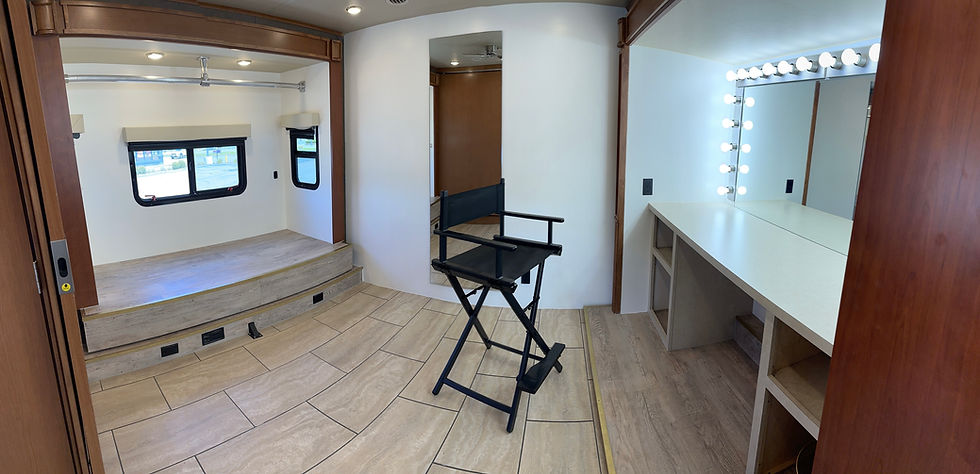 makeup and wardrobe compartment in motorhome rental depicting director chair and free work space.