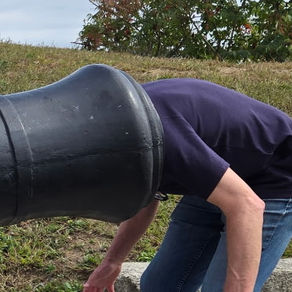A man with his head in a cannon.