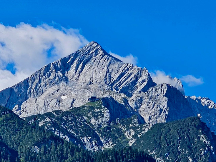 View of the sharp pyramid-shaped Alpspitze peak rising above Garmisch under a clear blue sky