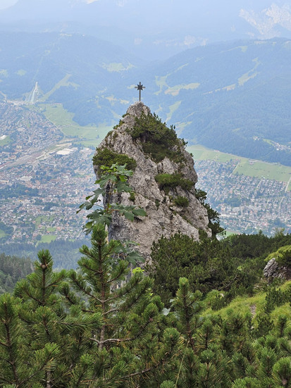 View of the summit cross on Kramer Mountain overlooking the town of Garmisch-Partenkirchen