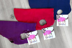 fleece dog jackets in red, purple, and navy