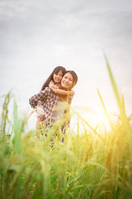 smiling-woman-giving-a-child-a-piggyback-ride-2026-03-26-06-58-54-utc.jpg