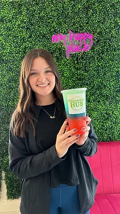 Student influencer holding a nutritous tea drink.webp