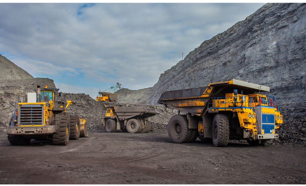 several large trucks at a mining site