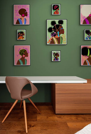 Beautiful vibrant artwork arranged in a gallery wall setting in a living room decor. Artworks feature beautiful African American black women with natural hair and are very colorful.