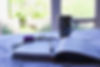 a contemplative scene of an open notebook at a window with a mug, pen and flowers.