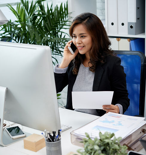 asian-business-lady-sitting-office-holding-document-talking-mobile-phoneGFHFGHGFHFGFG.jpg