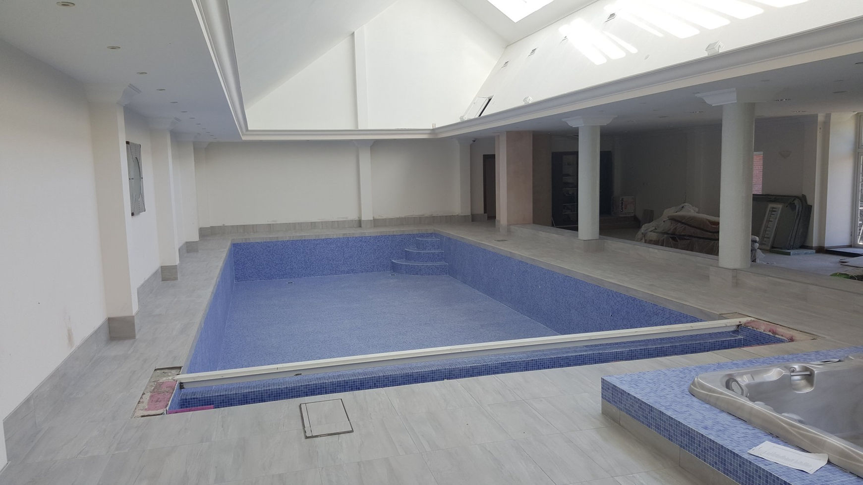 Large-format porcelain floor surrounding indoor pool, Macclesfield