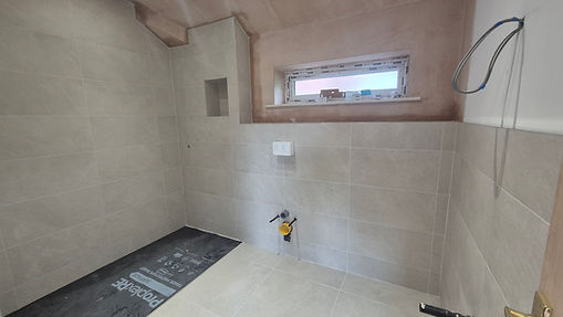 Large-format porcelain wall and floor tiling installation in Hale Barns new build extension