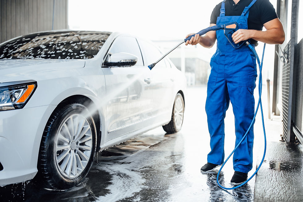 professional-washer-blue-uniform-washing-luxury-car-with-water-gun-open-air-car-wash.jpg