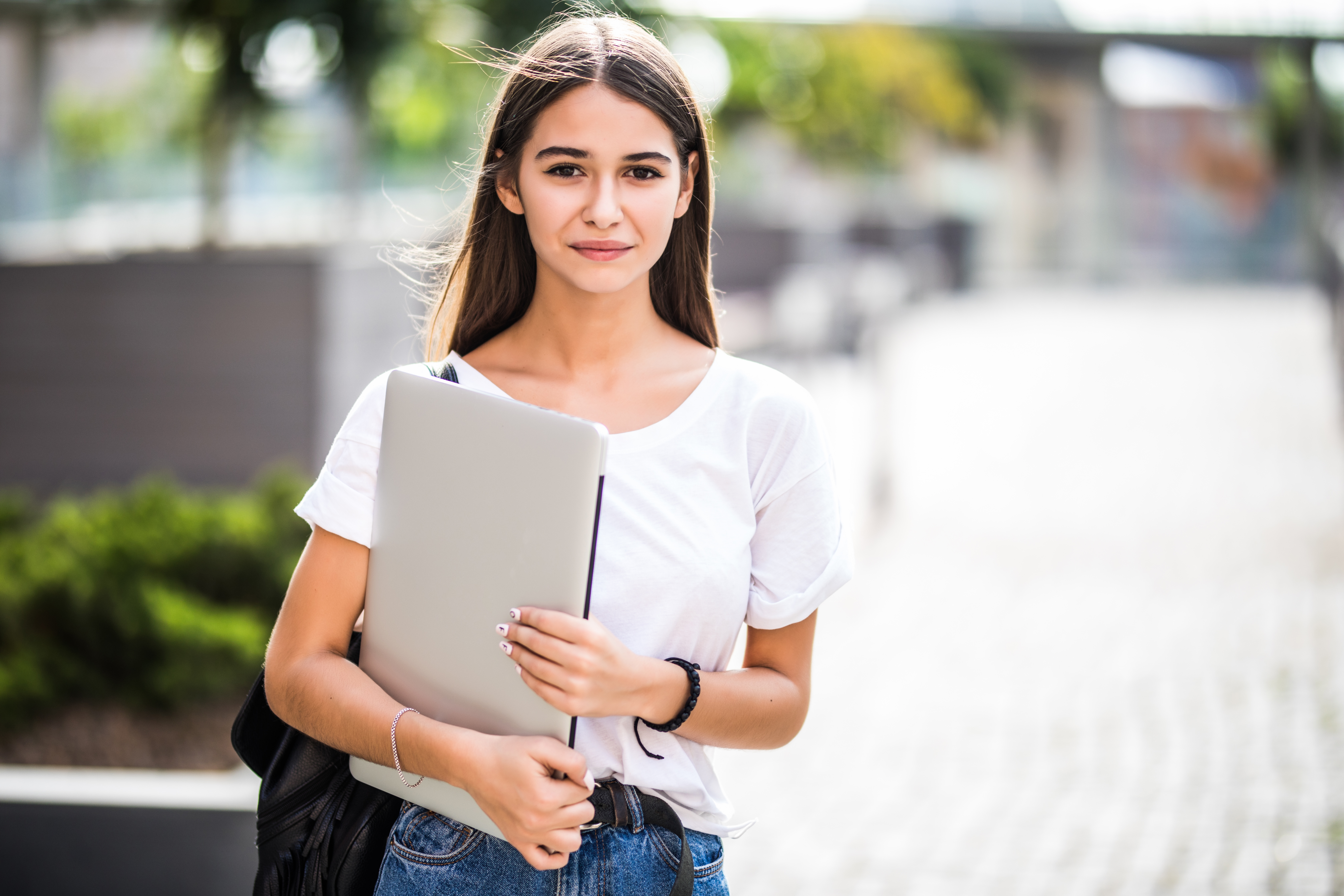 portrait-young-happy-blogger-with-modern-laptop-outdoors.jpg