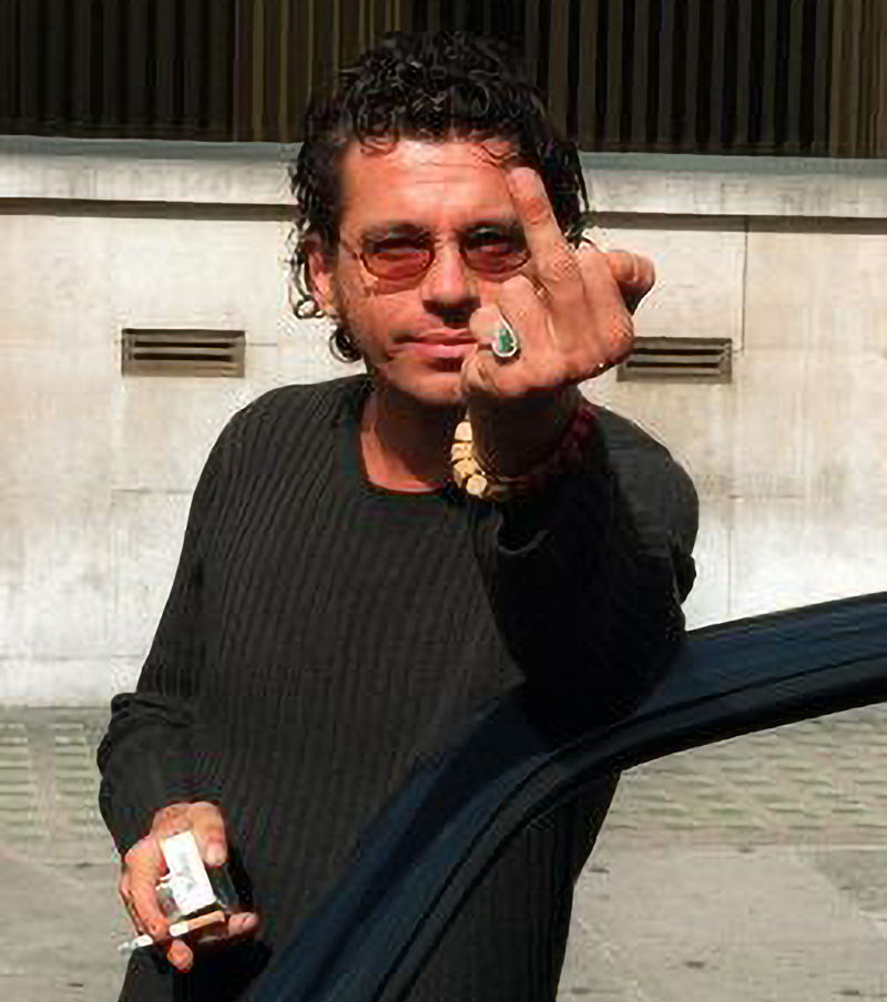 INXS lead singer Michael Hutchence giving a paparazzi photographer the bird