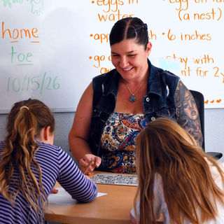 Teacher helping students during lessons.