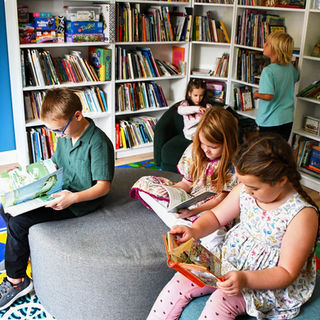 Children reading books in a classroom library