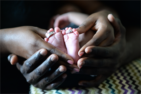 African American hands, baby feet