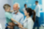 happy-nurse-holding-hands-communicating-with-small-kid-who-came-with-grandfather-clinic-fo
