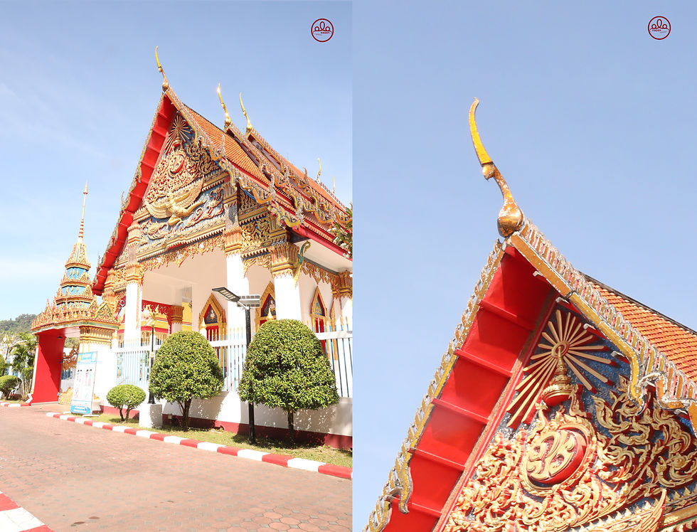 Ornately decorated Buddhist temple with intricate carvings and a vibrant red and gold roof, surrounded by neatly trimmed shrubs under a clear blue sky.