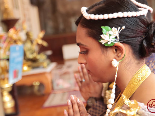 Couple praying during the vow-like ceremony in a private Thai wedding guided by monks