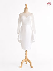 Elegant white mini bridal dress with illusion long sleeves, sweetheart neckline, sparkling bead embroidery, fitted satin skirt, and soft side drape details displayed on a mannequin against a clean white background.