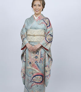 Model wearing a pastel blue Japanese kimono with crane and floral motifs, elegant traditional kimono from Pinder Select.