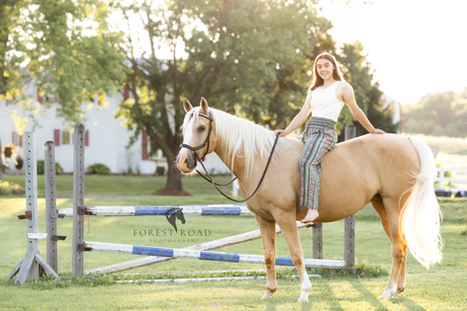 A High School Senior enjoying a sunlit evening bareback ride with her horse in Wisconsin