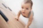 curious baby standing up baby proof