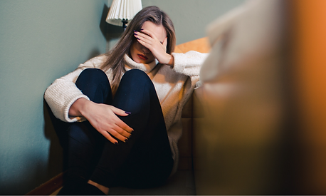 A woman upset sitting on the floor