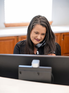 Front desk receptionist answering the phone