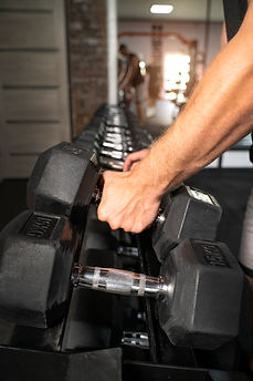 fit-man-holding-dumbbells-side-view.jpg