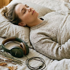 Woman lying peacefully listening to a hypnotherapy recording