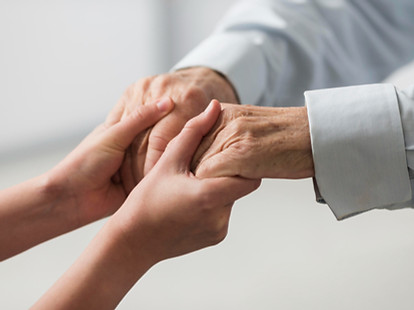 nurse-holding-senior-man-s-hands-sympath