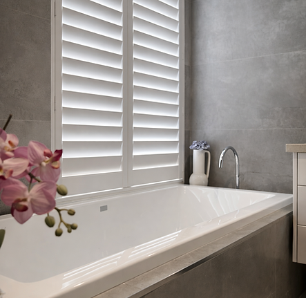 Serene bathroom with orchid and shutters.png