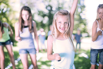 Young smiling girl raising her arm while winning race